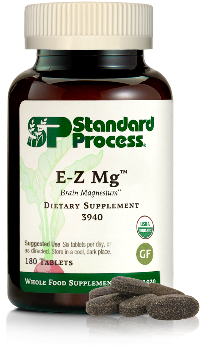 Image of E-Z Mg bottle next to tablets of magnesium supplements.