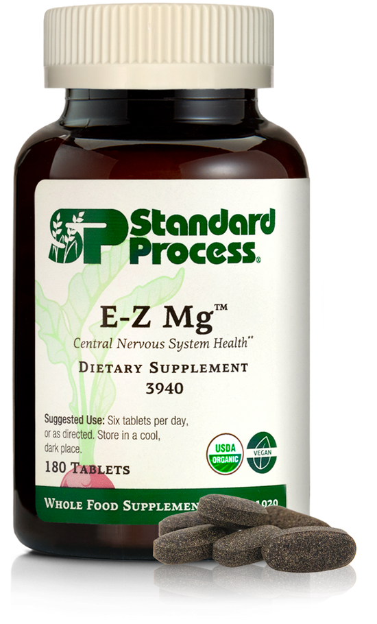 Image of E-Z Mg bottle next to tablets of magnesium supplements.